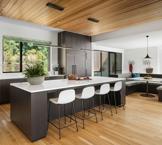 A wall removal opens kitchen to family room and beyond. BlueStar range, Vent-A-Hood liner and Sub-Zero fridge from Eastbank Contractor Appliances. Roche Bobois artwork adorns desk shelving.