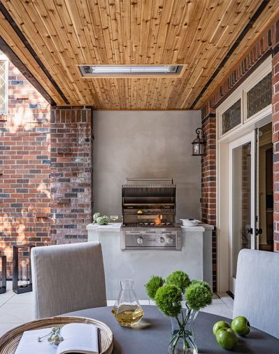Water-damaged patio gets facelift with Infratech heaters, cedar soffit. BBQ revamp utilizes plaster surround and wall, adds concrete countertop. Edgestar grill from Ferguson. Belgian concrete and teak Restoration Hardware table and chairs.