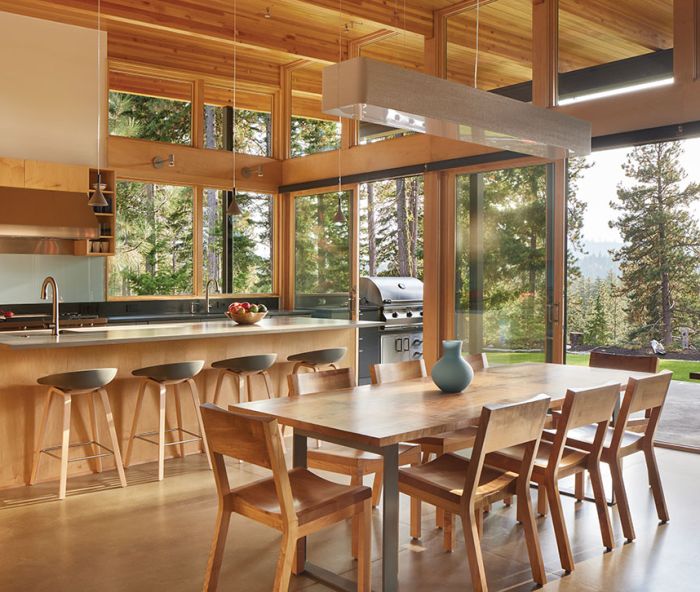 Natural Hemlock ceilings designed by Studio Zerbey and installed by Modern Millwork Design create a continuous line from indoors to out, visible through the large-scale Anderson E-Series windows and sliders from Washington Window and Door. Studio Zerbey Architecture + Interiors worked with the client to explore subtle design elements that nod toward air travel, including cable-suspended lighting from Resolute Lighting and North Coast Lighting and custom furniture from Chadhaus.