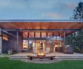 The custom firepit and bench are designed by Studio Zerbey with installation by Western Metal Products, Rodman Construction, and Centerline Artworks. The weathered Corten Steel Panels that frame the outdoor grilling station and provide privacy to the adjacent bedroom match the fireplace mantel in the great room.