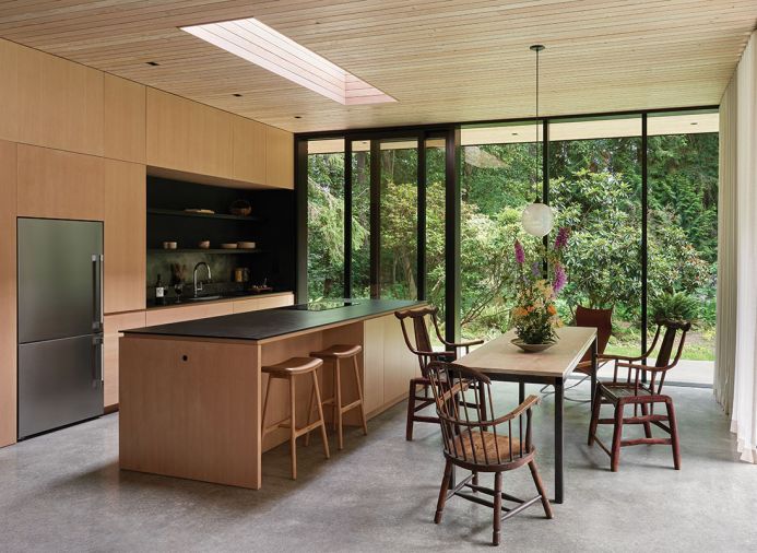 Designed by GO'C and built by Sparrow Woodworks the custom cabinetry nestles appliances from Albert Lee. Douglas Fir shelving above the sink was milled on-site and ebony stained.