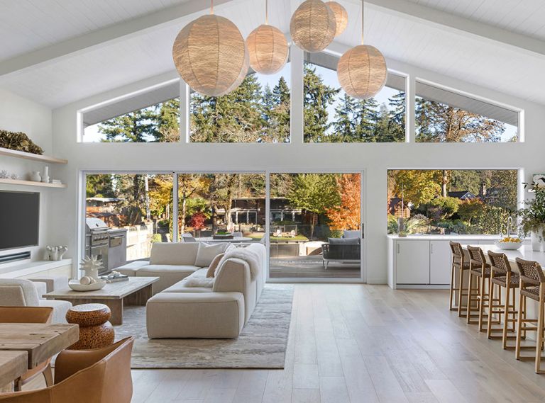 Vanillawood reorganized the layout of this Lake Oswego bungalow so all of the main living spaces now benefit from a rear wall of glass with views of the lake. The wood floors were sourced through Contract Furnishings Mart.