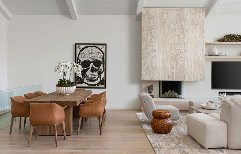 In the living room, Vanillawood specified unfilled travertine from Italy, fabricated by Artistic Stone Design, to wrap the fireplace. The custom artwork is by Steven Tyler.