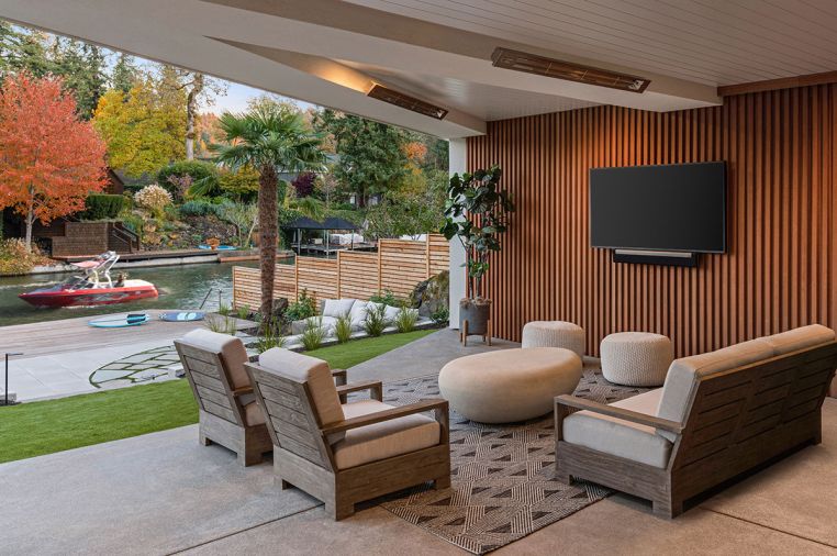 Kayu International wood slatting covers the wall in the protected outdoor room, which also has Infratech heaters and a loveseat and chairs from Restoration Hardware.