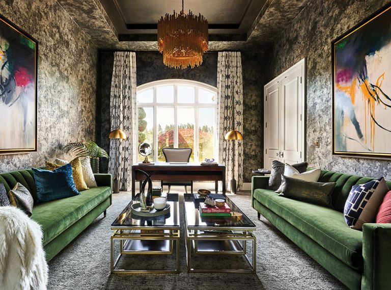 Step into a room where furnishings, textures, colors and Scalamandre wallpaper evoke conversation. Velvet Sunpan sofas pair with Sonder Living coffee tables, plush Lexmark carpet, and Stacey Garcia custom drapes. Arteriors Prescott 2-tiered chandelier lights artwork from Left Bank.