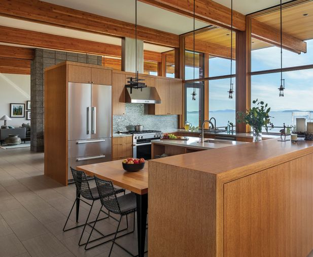 In the kitchen, a Perfect Cool French Door Refrigerator and 36' Pro-style Duel-Fuel range, both Miele, from DeWaard & Bode. Wood paneling and cabinetry by K&S Woodworks.