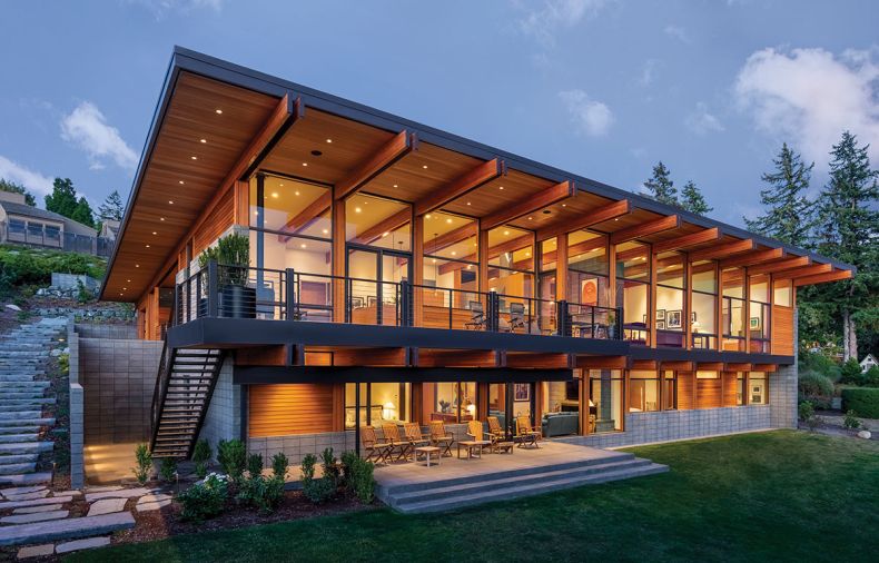 Ground Face CMU Block, laid in a stacked bond pattern from Bouwman Masonry, forms retaining walls and covers exterior portions of the house to protect it from harsh weather. The Sierra Pacific windows and doors clad over VG Fir from Island Sash and Door Inc.