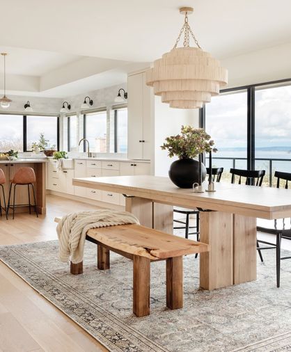 The dining room lighting and Ethnicraft table are from McGee & Co. Benjamin Moore Simply White paint ties the space together. In the living room, the fireplace has a mantle made by the homeowner.