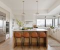 In the kitchen, the Newtons sourced the Kitchen Aid wall ovens, Wolf range, and Sub-Zero refrigerator from Metropolitan Appliance. The Newport Brass plumbing fixtures are from Ferguson. The quartz stove backsplash and counter is by Daltile.