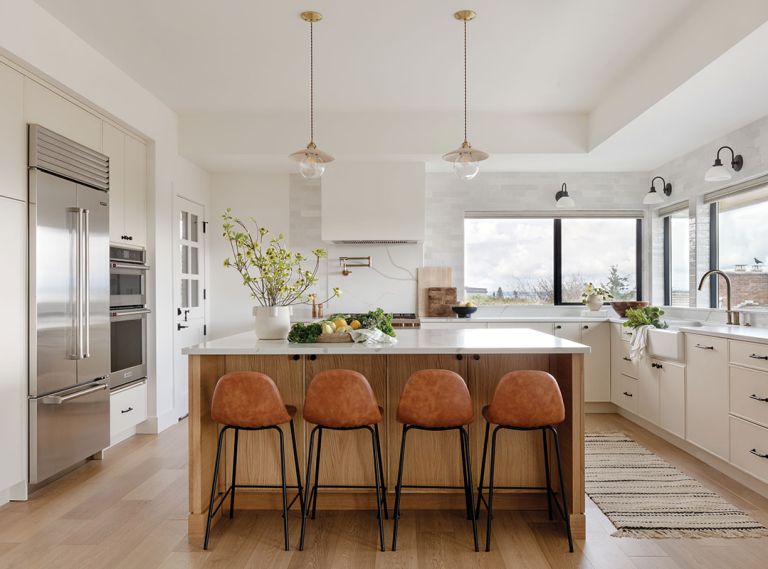 In the kitchen, the Newtons sourced the Kitchen Aid wall ovens, Wolf range, and Sub-Zero refrigerator from Metropolitan Appliance. The Newport Brass plumbing fixtures are from Ferguson. The quartz stove backsplash and counter is by Daltile.