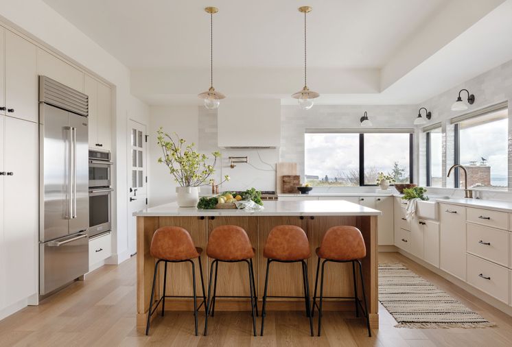 In the kitchen, the Newtons sourced the Kitchen Aid wall ovens, Wolf range, and Sub-Zero refrigerator from Metropolitan Appliance. The Newport Brass plumbing fixtures are from Ferguson. The quartz stove backsplash and counter is by Daltile.