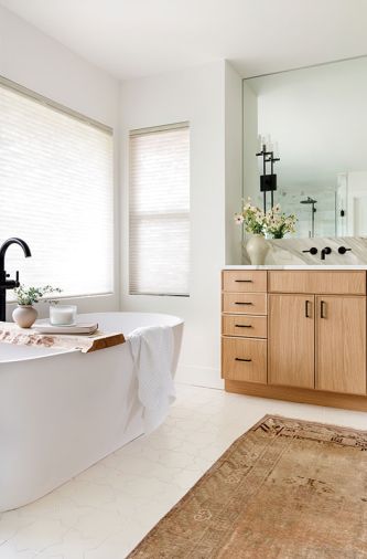 At the soaking tub, the Delta Faucet by Stilly Valley Plumbing is from Keller Supply, while the homeowner made the bath tray.