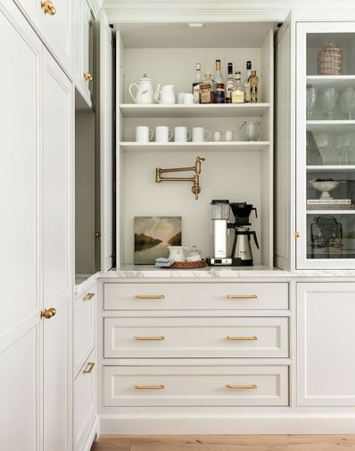 The beverage station includes a faucet, ample storage, and proximity to a beverage refrigerator. The cabinet’s “flipper” doors tuck back into the wall out of the way of traffic.