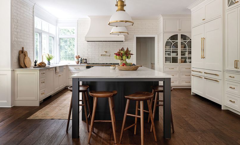 Unlacquered brass hardware like the faucet from Build.com will organically patina over time for a warm, lived-in look. The Lacanche stove is entirely mechanical, and modern appliances have been artfully obscured.