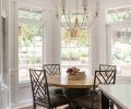 The nook features a “Paris Flea Market” chandelier that balances the traditional crystal chandeliers in the entry and dining and the island’s vintage-look pendants.