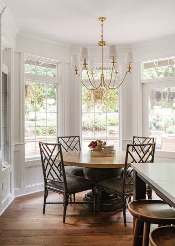 The nook features a “Paris Flea Market” chandelier that balances the traditional crystal chandeliers in the entry and dining and the island’s vintage-look pendants.