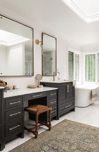 The main bathroom is a sanctuary for self-care, including a built-in sit-down makeup vanity, radiant heat marble floors, and a modern soaking tub that nods to the traditional clawfoot style.