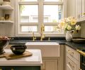 The functional kitchen looks traditional on the surface by obscuring modern appliances behind the cabinetry and featuring enduring materials like unlacquered brass from Rejuvenation and natural granite. The lighting is from Schoolhouse Electric. The Newport brass faucet and Barclay sink are from Fergusons.