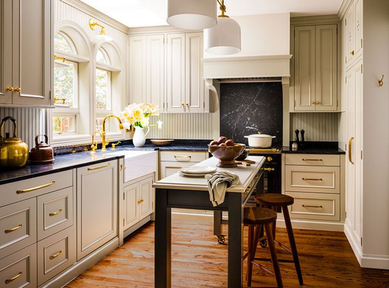 Cabinetry by Bevel obscures the modern appliances, creating a calm, uncluttered finish. The island’s wood frame features a black lacquer paint to coordinate with the range.