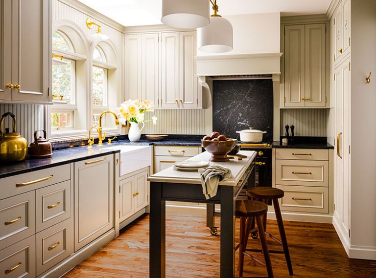 Cabinetry by Bevel obscures the modern appliances, creating a calm, uncluttered finish. The island’s wood frame features a black lacquer paint to coordinate with the range.