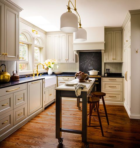 Cabinetry by Bevel obscures the modern appliances, creating a calm, uncluttered finish. The island’s wood frame features a black lacquer paint to coordinate with the range.