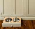 Pull-out dog food and water station topped with a knob from House of Antique Hardware is stashed in the baseboard.