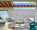 Custom chairs, coffee table and sectional are by Garret Cord Werner Architects and Interior Designers. Picking up the crisp blue of the water, an elegant Bell Side Table with aqua glass bottom and gold inverted cylinder from Inform Interiors.