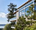 The view through the house follows the pool, from the reflecting pond by the entry, to rear views of Lake Washington.