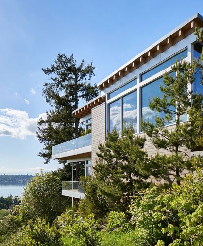 The view through the house follows the pool, from the reflecting pond by the entry, to rear views of Lake Washington.