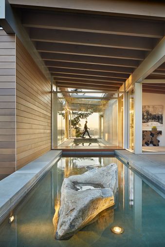 Vertical grain cedar siding with hidden fasteners helps the house blend into the trees.