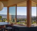 Inside and outside dining areas sit in tandem across a corner of glazing outfitted with a custom built-in storage bench, which houses the homeowner’s extensive record collection.