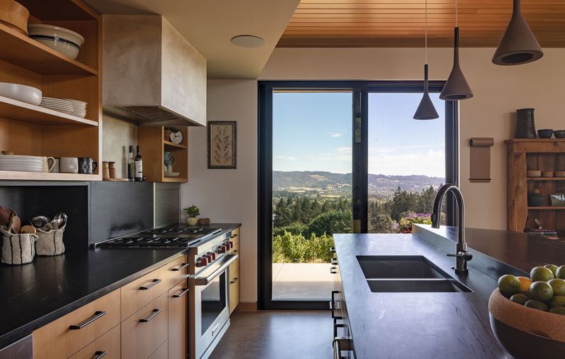 Globe Lighting supplied the illumination throughout the house, including the iconic Noguchi Akari lantern over the dining table and the Foscarini Aplomb pendants for the working island. The kitchen is a serene mix of fir cabinetry from Big Branch Woodworking topped in black soapstone. Appliances from Eastbank Contractor Appliances play big in the modest footprint.