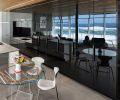 Pacific Design island and their “nFusion” laminated black painted glass cabinet fronts reflect the ocean view. Sub-Zero refrigerator, Miele cooktop, oven and dishwasher from Eastbank Contractor Appliances and countertops by Stone Center, Inc.
Photo by Justin Krug