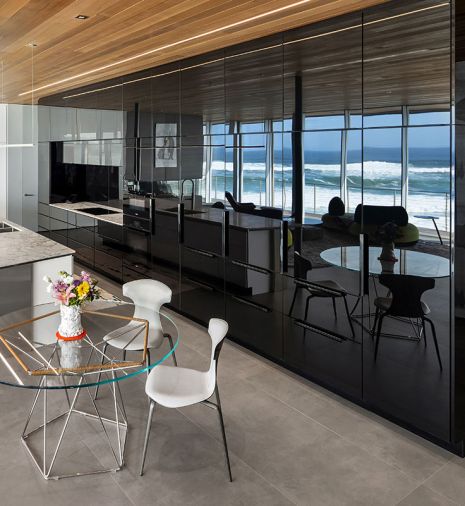 Pacific Design island and their “nFusion” laminated black painted glass cabinet fronts reflect the ocean view. Sub-Zero refrigerator, Miele cooktop, oven and dishwasher from Eastbank Contractor Appliances and countertops by Stone Center, Inc.
Photo by Justin Krug