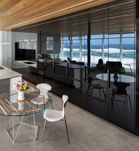 Pacific Design island and their “nFusion” laminated black painted glass cabinet fronts reflect the ocean view. Sub-Zero refrigerator, Miele cooktop, oven and dishwasher from Eastbank Contractor Appliances and countertops by Stone Center, Inc.
Photo by Justin Krug