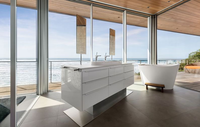 The floating vanity by Pacific Design boasts “nFusion” glass fronts and countertop from Stone Center, Inc. WS Bath counter-mount mirrors appear to float above sinks.
Photo by Justin Krug