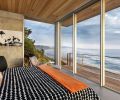 Guest bedroom which features the best ocean view includes comfy Roche Bobois Dolphin chair and ottoman and European sliding doors. Ipe decking from Bison Innovative Products serves as all-important window washing locale.
Photo by Justin Krug