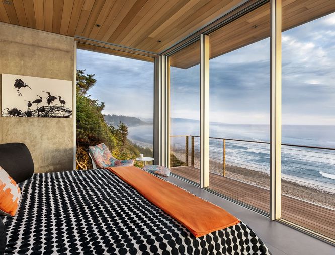 Guest bedroom which features the best ocean view includes comfy Roche Bobois Dolphin chair and ottoman and European sliding doors. Ipe decking from Bison Innovative Products serves as all-important window washing locale.
Photo by Justin Krug