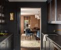 Butler’s pantry illuminated by Halcyon sconce and Hudson Valley Middlebury Flush Mount lighting. A GE Monogram wine fridge is tucked under Mely Gray limestone counters.