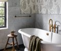 The tub area features a Vervain wallcovering, Bedrosians Carrara honed marble wall and a Victoria & Albert Traditional Double-Ended tub.
