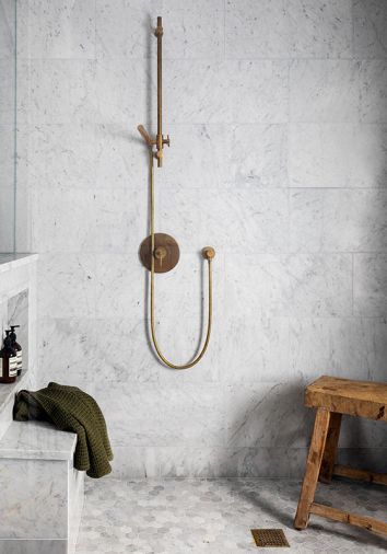 Watermark plumbing atops Bedrosians Carrara honed marble walls.