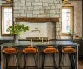 The kitchen is a focal point in Sherri and Ali Anissipour’s Suncadia home, with custom cabinetry by United Cabinetry, a weathered white zellige tile backsplash, soapstone counters, and a custom range surround by designer Jessica Nelson and WoodRidge Custom Homes.