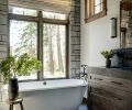 In the primary bathroom, find Cle Tile flooring, soapstone counters, and a feature wall with Bluestone. Signature Hardware tub from Build.com.