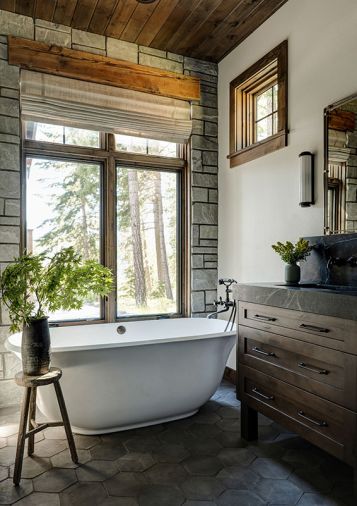 In the primary bathroom, find Cle Tile flooring, soapstone counters, and a feature wall with Bluestone. Signature Hardware tub from Build.com.