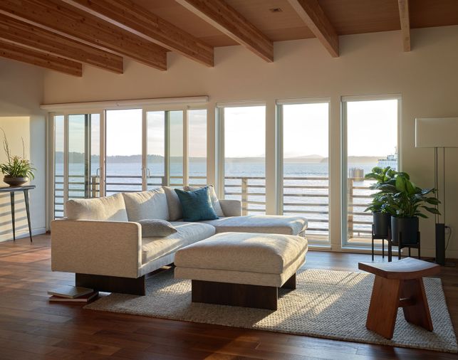 The west-facing windows and doors, both upstairs and down, are covered with solar-sensored blinds to protect the house from solar gain. The standing lamp is from Seattle Lighting.