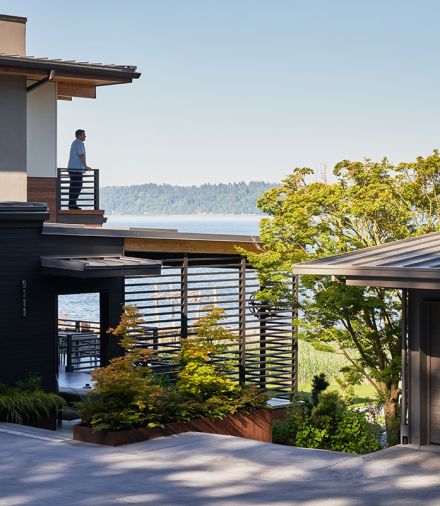 The exterior railings and Ipe decking were provided by Lindal Cedar Homes, while the iron planters were built by Schaefer Construction.