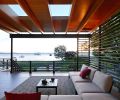 In the protected side porch, “We wanted to create that vertical slat wall so that the wind coming from that side is essentially diffused a little bit,” says Uomoto. “It also acts as privacy from their close neighbors.” Porcelain pavers are from Mutual Materials.