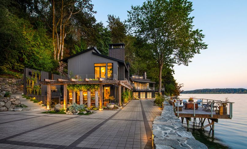 This 6,880-square-foot Bremerton home was remodeled in 2023. The architects redesigned the driveway with Park Permeare in pewter with charcoal accents from Western Interlock Inc. to give it more character. Exterior lighting provided by Northwest Outdoor Lighting.