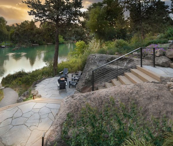 The lower patio is composed of New York blue flagstone from Mutual Materials, while the custom steel railing is from Ponderosa Forge.