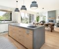 The kitchen’s concrete counters sync with the cement surround and hearth in the living room, both from Cement Elegance. The rift-cut white oak flooring throughout is from Castle Bespoke.